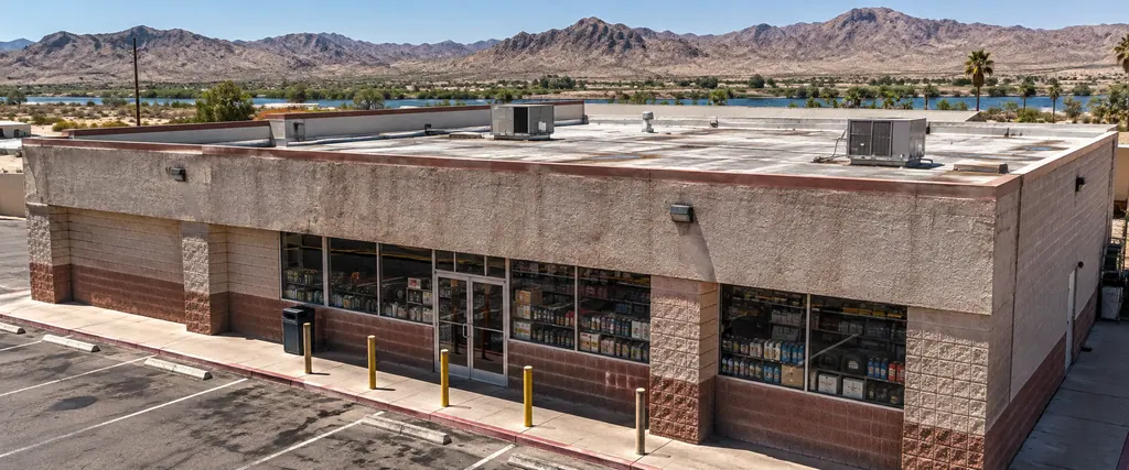 Single-story retail building with a flat roof and rooftop units